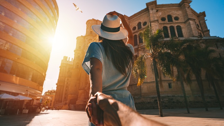 Woman holding man's hand 