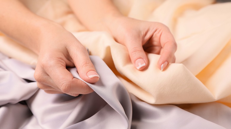 Woman comparing bedsheets