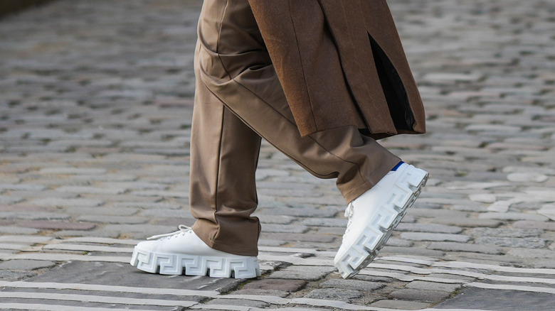 woman wearing white leather platform sneakers