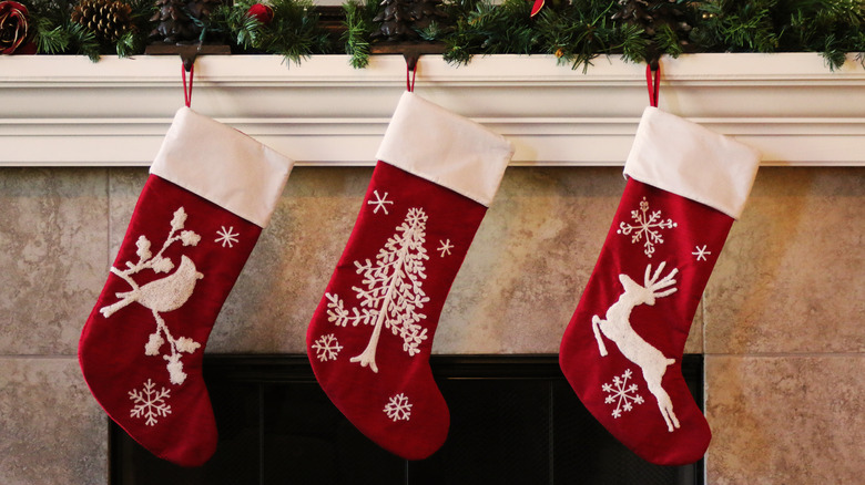 Christmas stockings hanging in front of a fire
