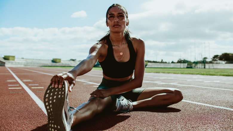 Female runner stretching her legs