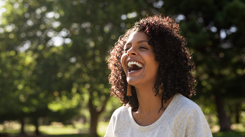 Woman laughing while outside in the sun