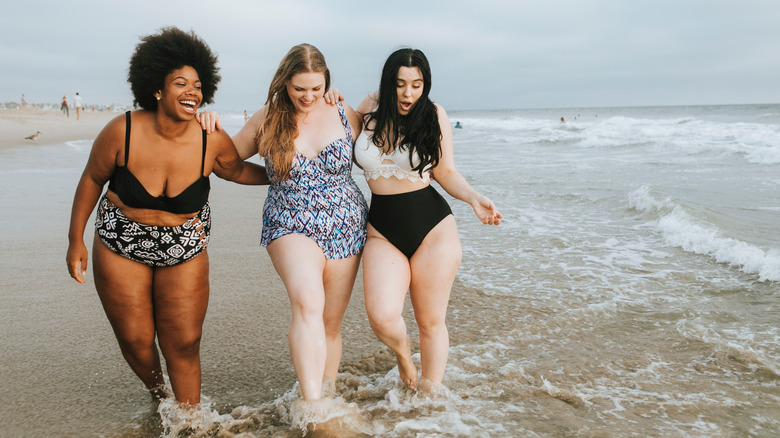 Women wearing swimsuits at the beach