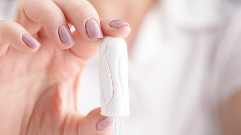 woman holding tampon