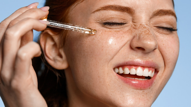 Woman using face serum