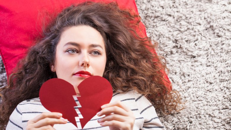 Woman holding broken heart