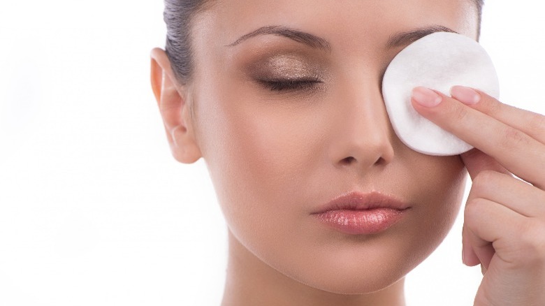 Cotton pad removing woman's makeup