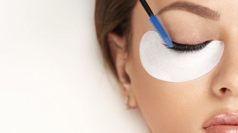 Woman receiving eyelash treatment