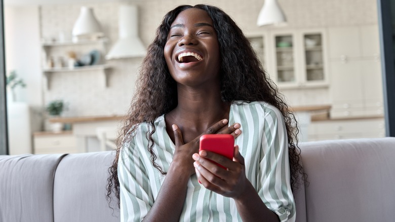 Woman smiling holding phone