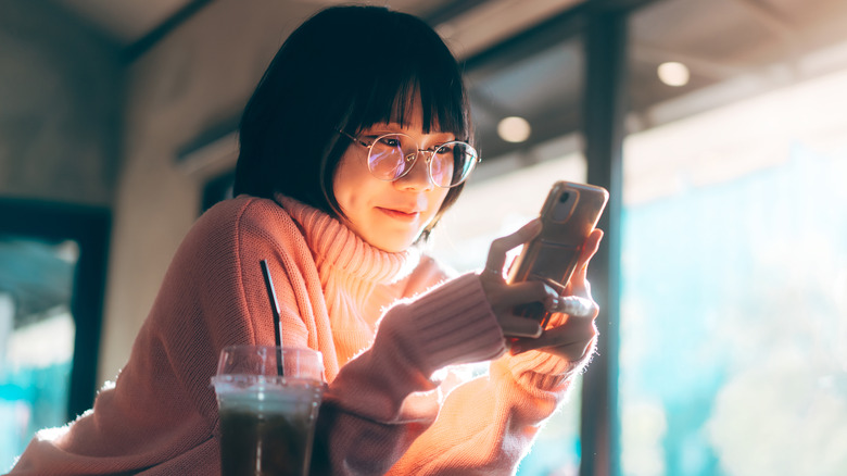 Woman on phone at cafe