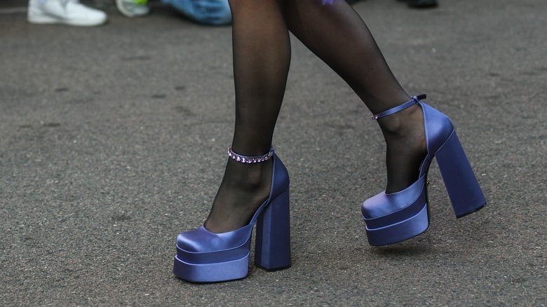 Close up of woman wearing blue platform heels