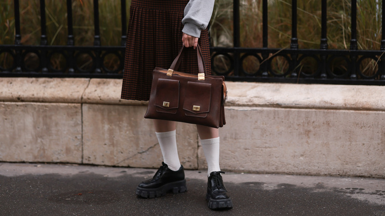 woman holding purse outside