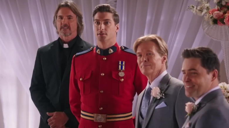Daniel Lissing in a Mountie uniform standing in the middle of a wedding ceremony