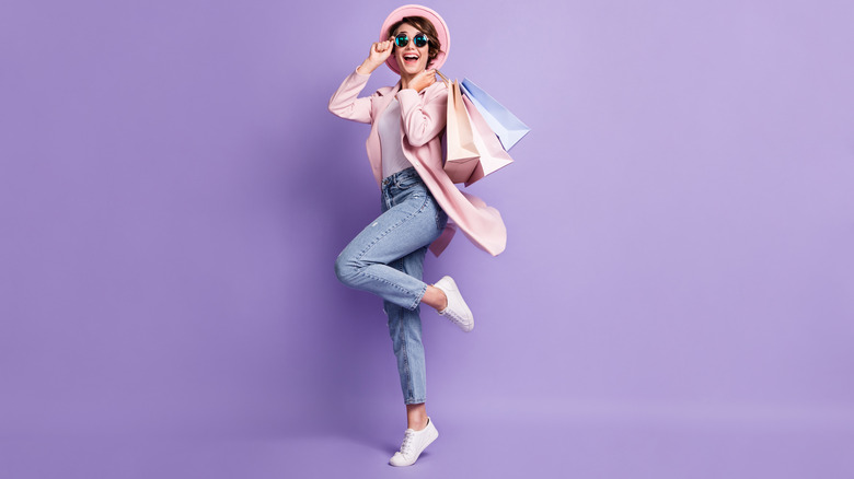 Woman with shopping bags wearing white sneakers