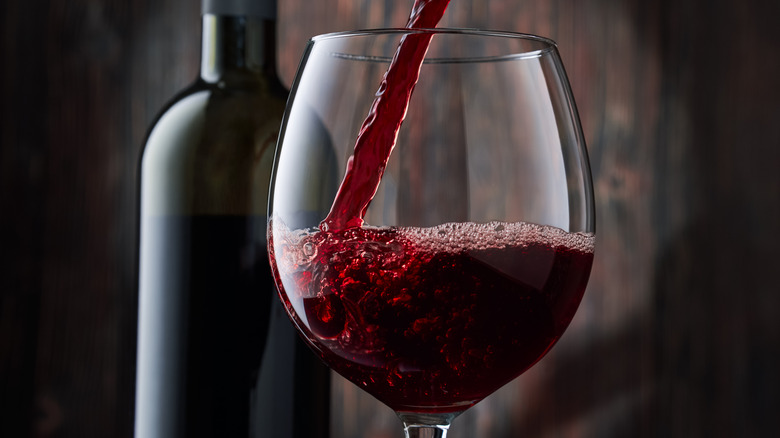 Red wine being poured into a glass