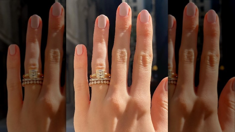 hand wearing diamond rings