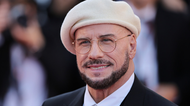 John Travolta smiling and wearing a beret
