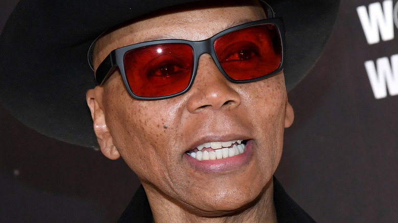 RuPaul wearing sunglasses and a cowboy hat