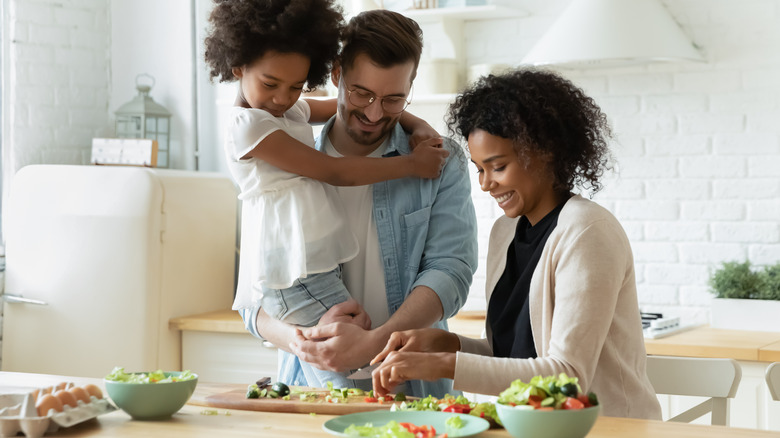 Interracial family making a salad