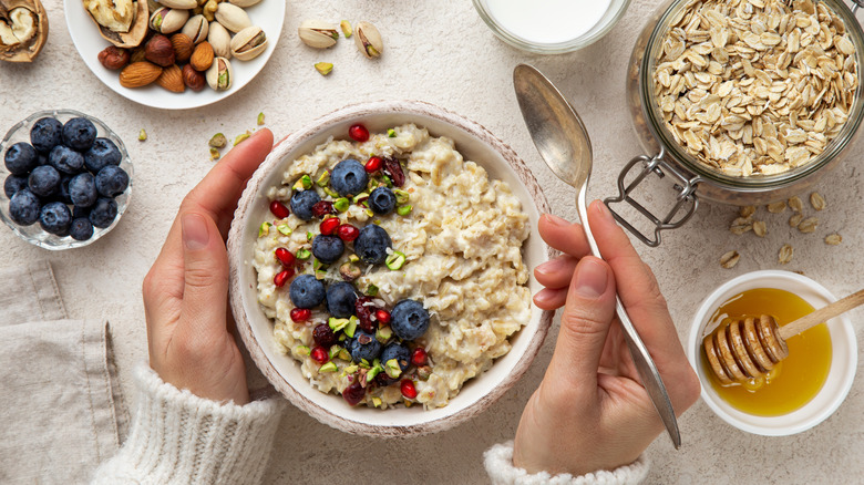 bowl of oatmeal, blueberries, and other healthy foods