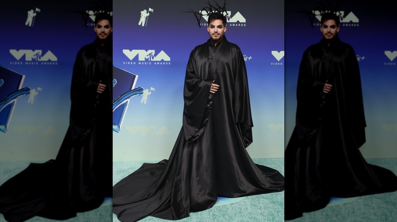 Adam Lambert wearing a long, black cloak