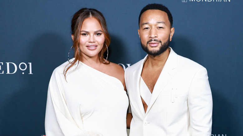 Chrissy Teigen and John Legend twinning in white