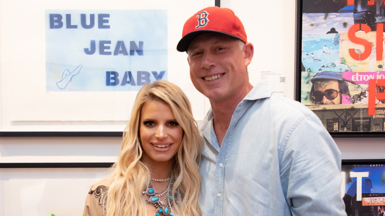 Jessica Simpson and Eric Johnson smiling at an art exhibition