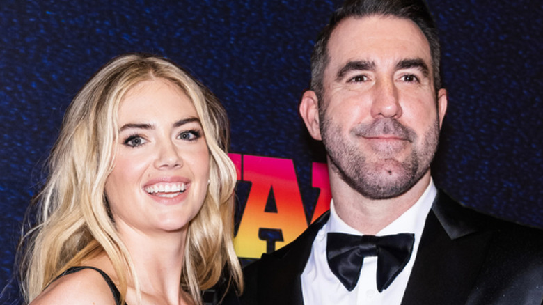 Kate Upton and Justin Verlander smiling in black formals