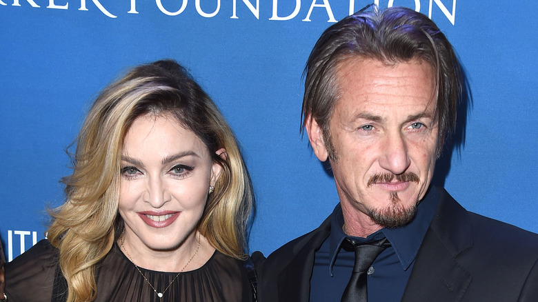 Sean Penn and Madonna smiling on a step-and-repeat