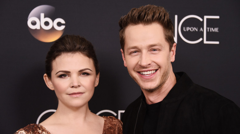 Ginnifer Goodwin and Josh Dallas posing on a step-and-repeat