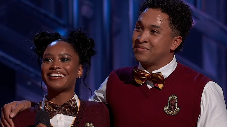 Ciara Miller and Brandon Armstrong listening to "Dancing with the Stars" judges' critiques and smiling