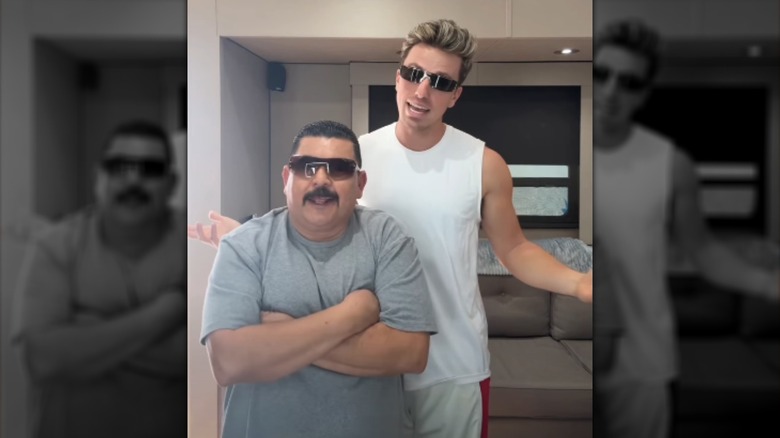Jackson Olson and Guillermo Rodriguez, both wearing sunglasses and workout clothes, dancing to camera