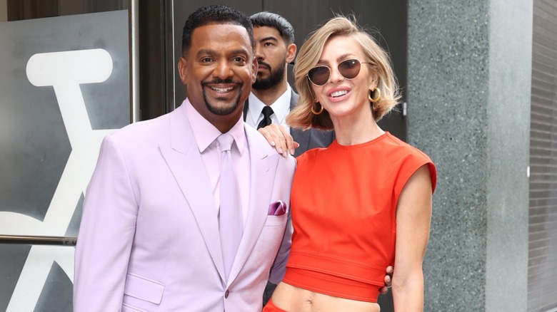 "Dancing with the Stars" hosts Alfonso Ribeiro and Julianne Hough arm-in-arm on the street in New York