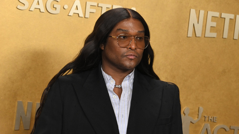 Law Roach pouting on the red carpet in some thin framed sunglasses and a black blazer