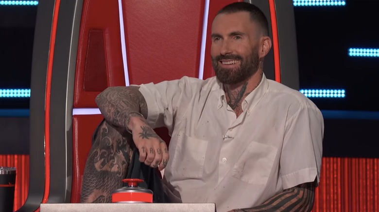 Adam Levine doing his signature leg on the chair pose on "The Voice"