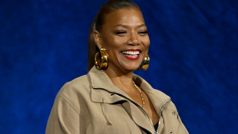 A close-up of Queen Latifah smiling onstage at CinemaCon 2026.