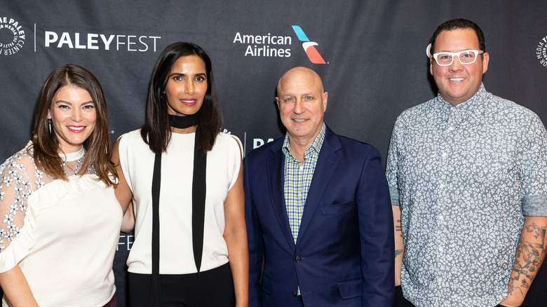 the judges of Top Chef gathered and smiling at the camera 