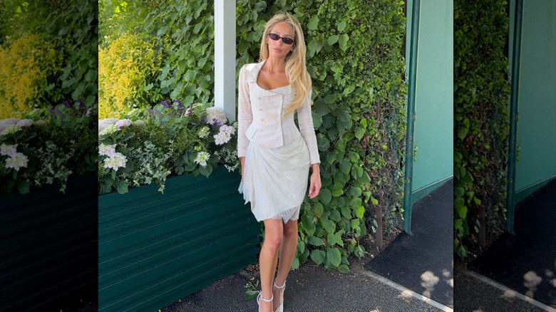 Alix Earle poses in an all-white outfit