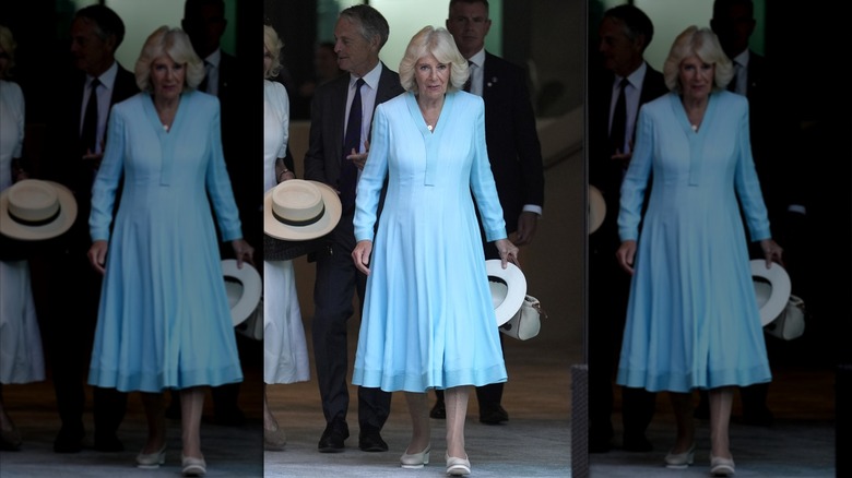 Queen Camilla walks in a blue dress at Wimbledon