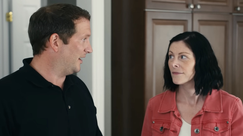 A woman looks at her husband skeptically with an eyebrow raised in an episode of Love It or List It