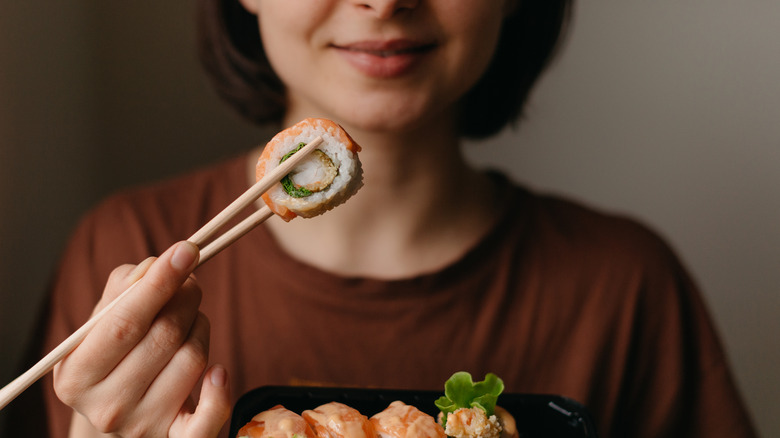 woman holding chopsticks