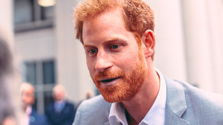 Prince Harry smiling and listening