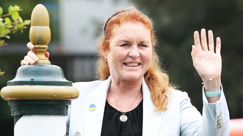 Sarah, Duchess of York, waving to photographers in the 2020s.