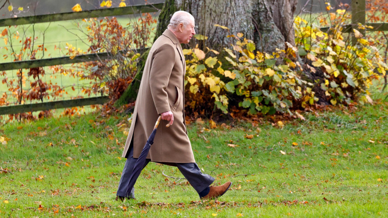 King Charles III walking in the grounds at Sandringham