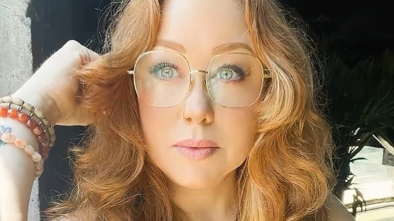 Meg Ferguson wearing big eyeglasses and bead bracelets