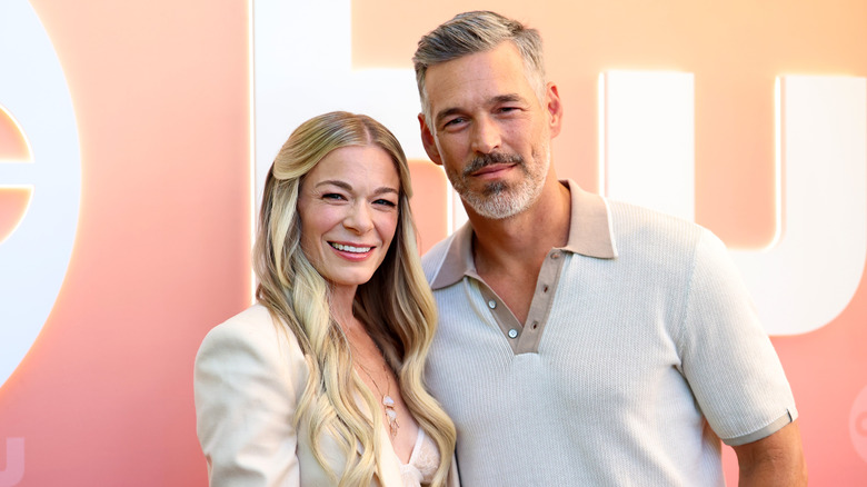 LeAnn Rimes in cream blazer with long hair and Eddie Cibrian in cream and tan shirt