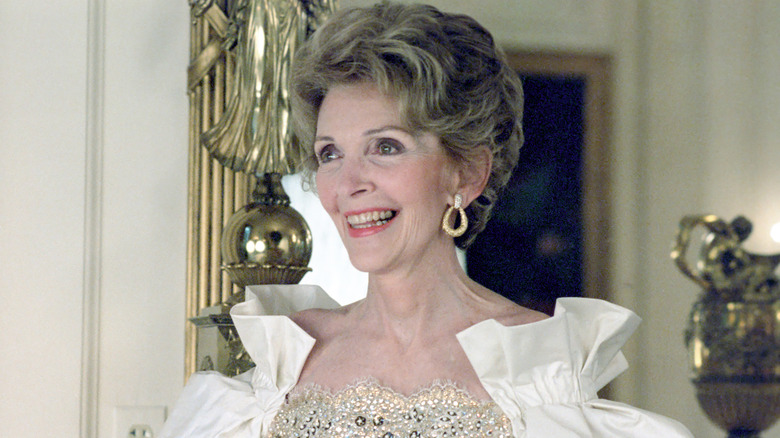 Nancy Reagan smiling in a fancy dress