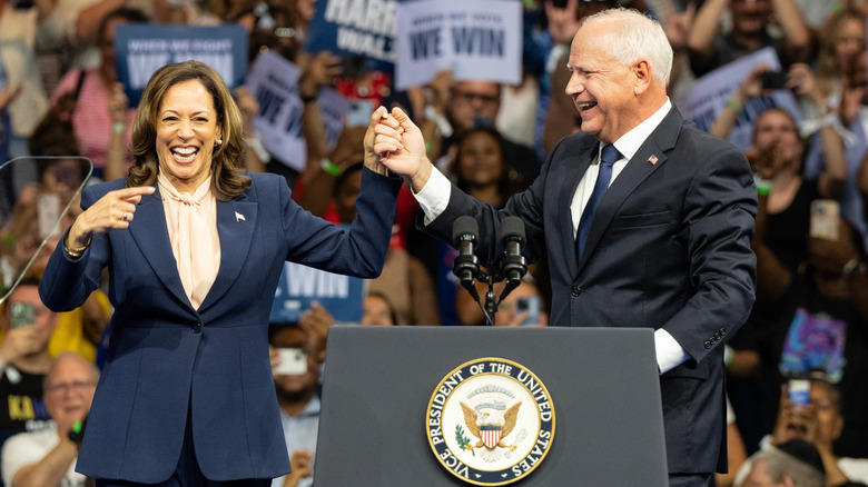 Kamala Harris and Tim Walz posing for a photo