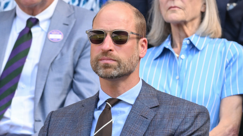 A serious-looking Prince William wearing sunglasses