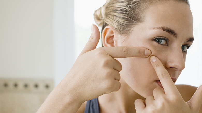 Woman squeezing her face